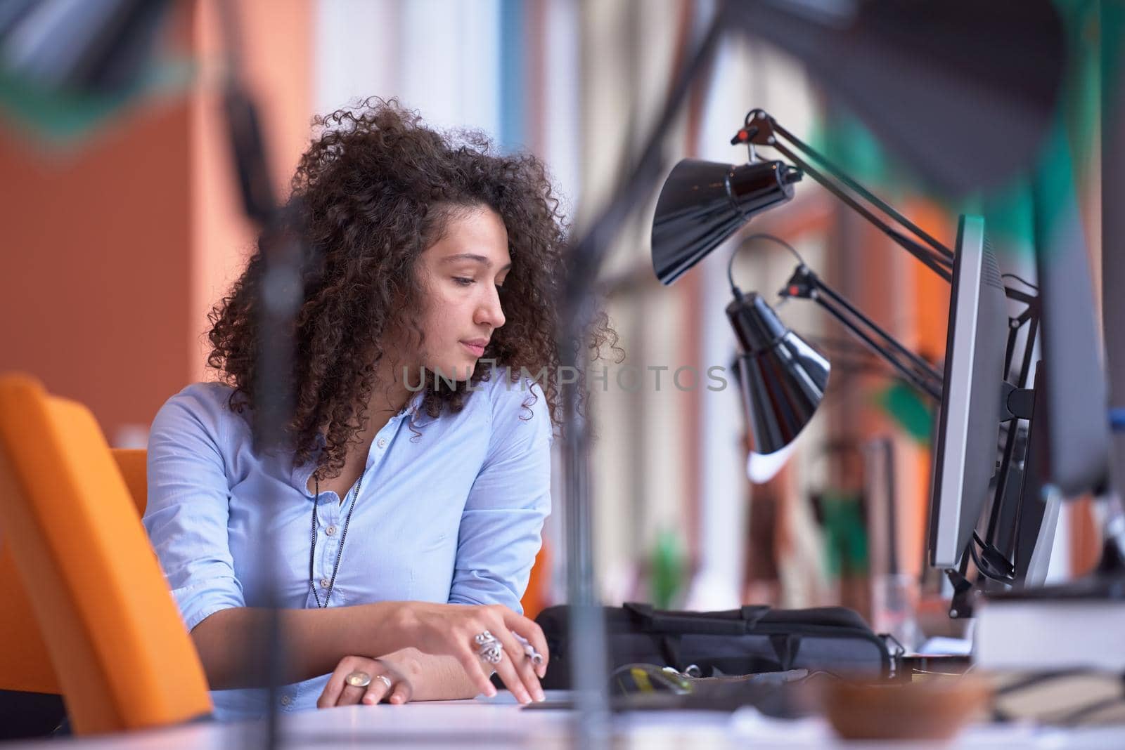 happy young  business woman with curly hairstyle in the modern office