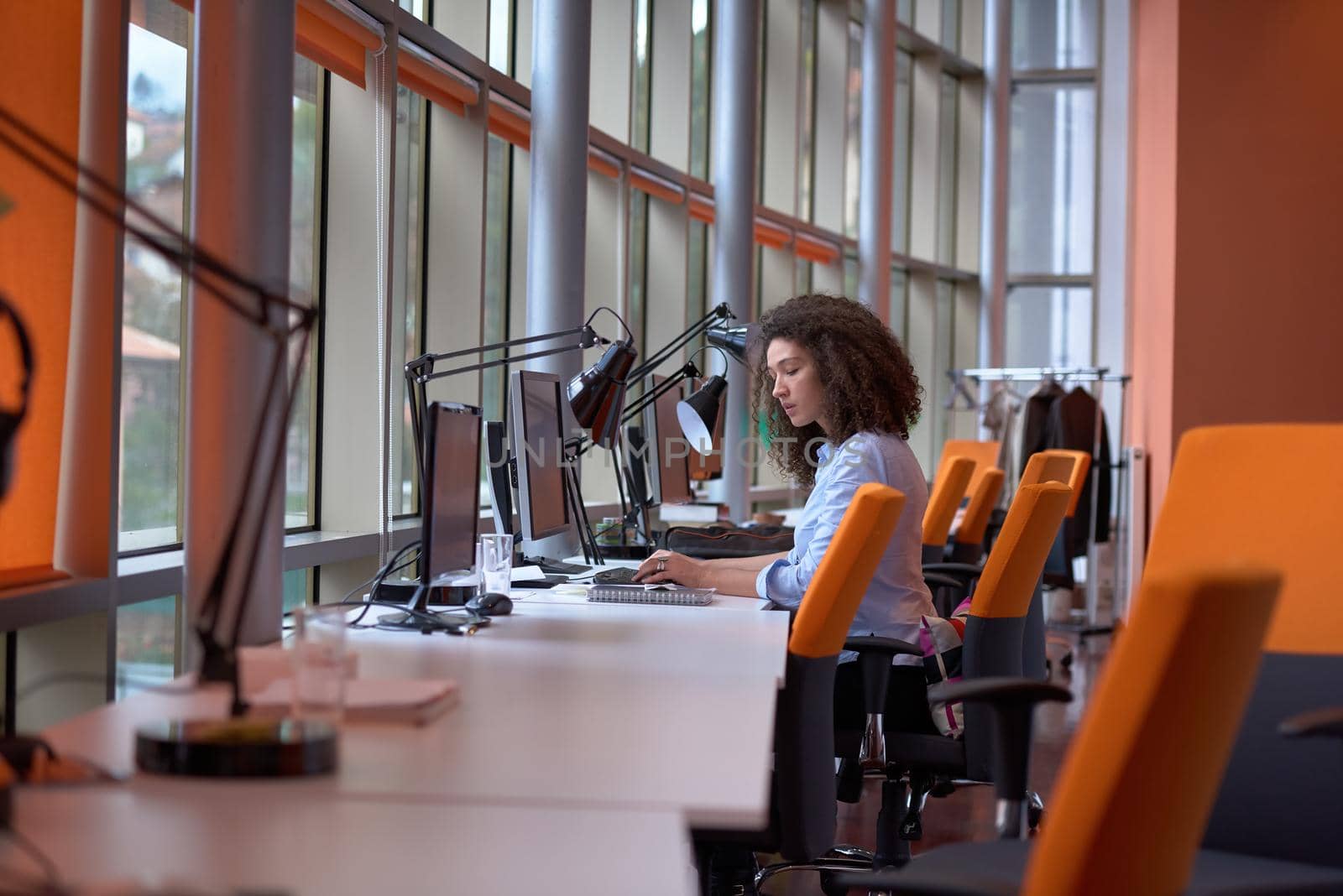 happy young  business woman with curly hairstyle in the modern office