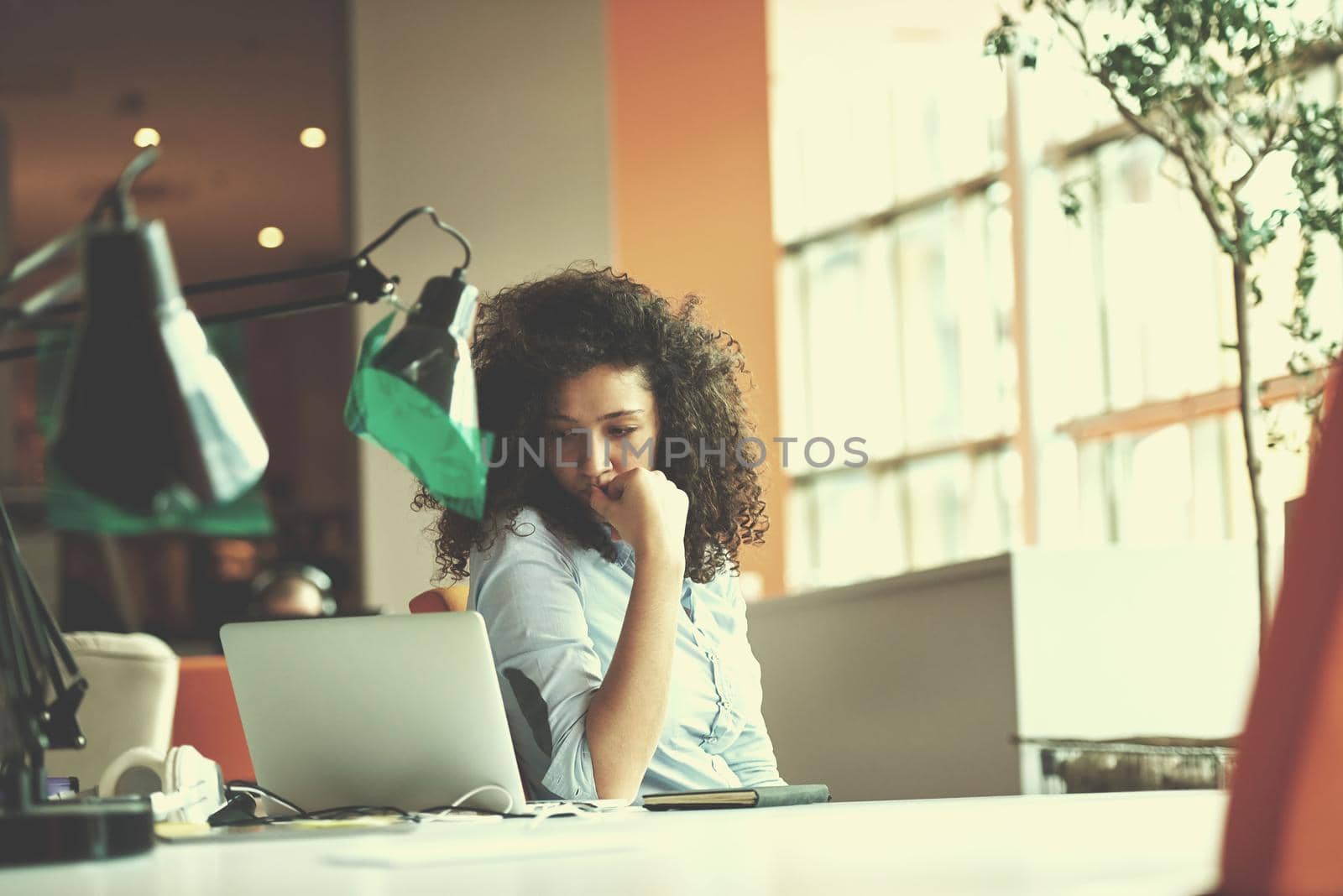 happy young  business woman with curly hairstyle in the modern office