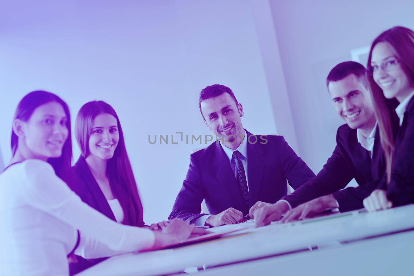 Group of happy young  business people in a meeting at office