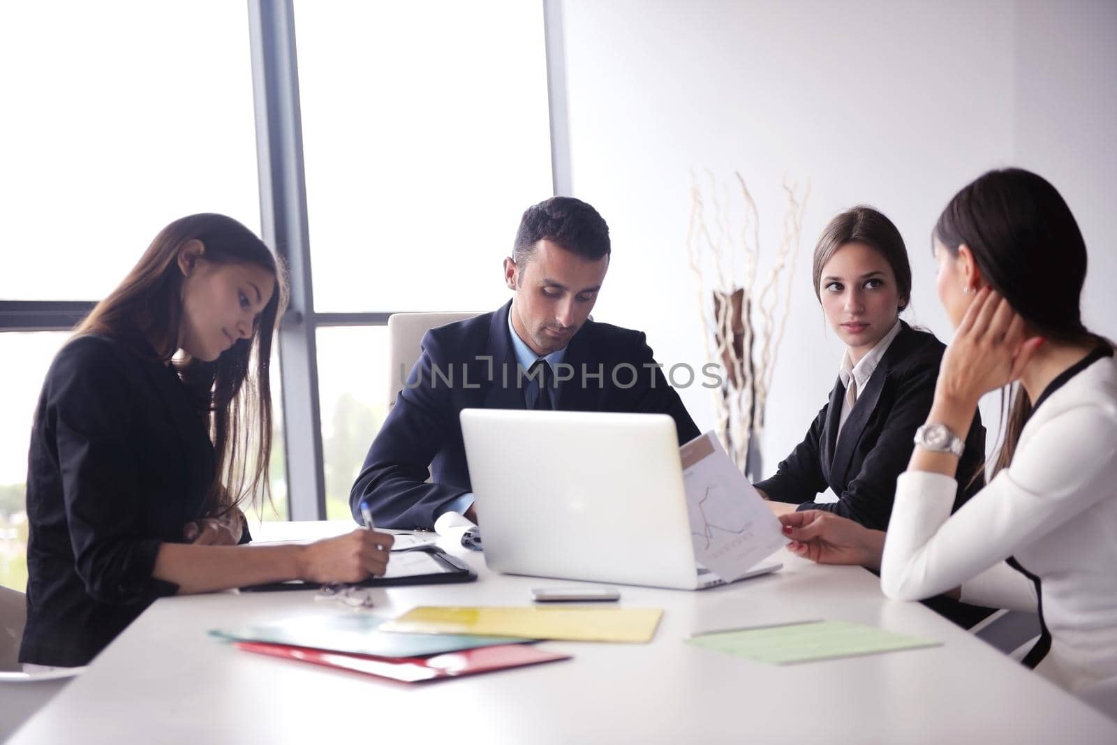 Group of happy young  business people in a meeting at office