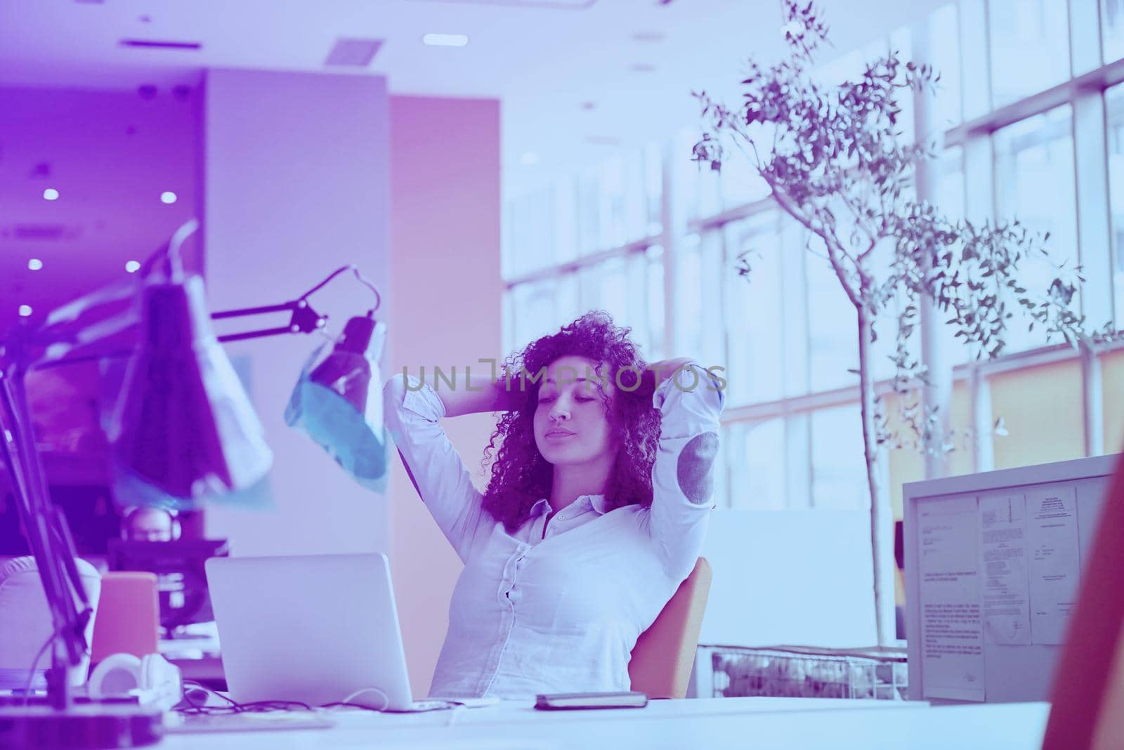 happy young  business woman with curly hairstyle in the modern office