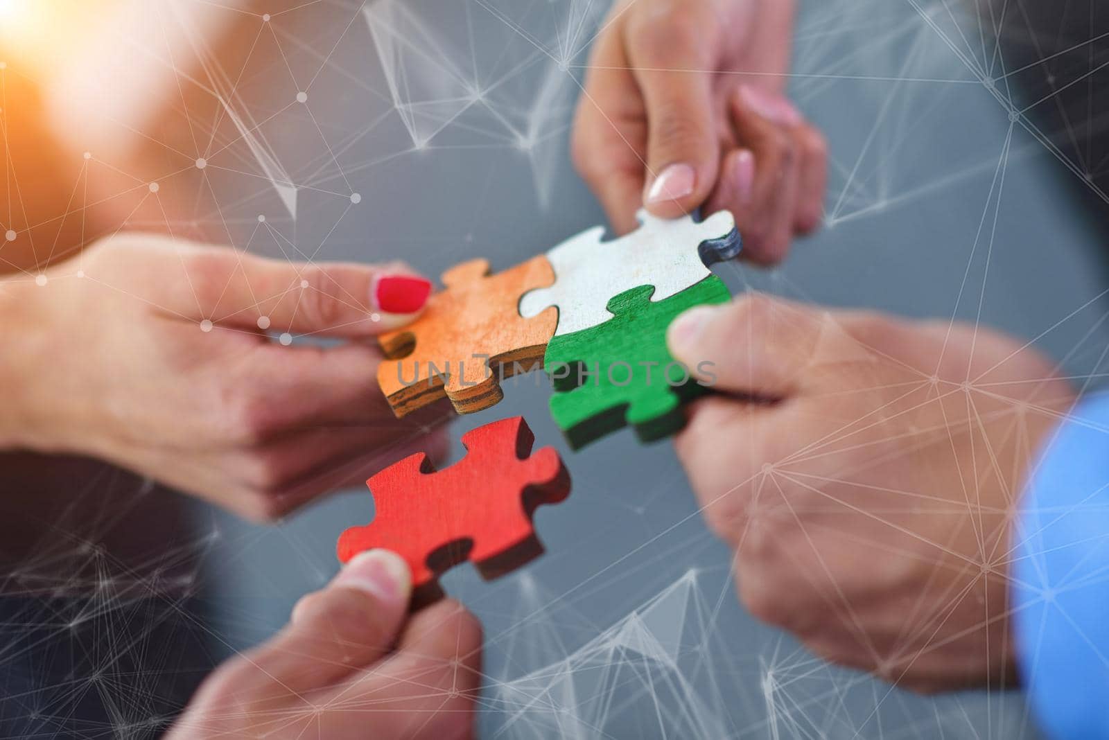 Group of business people assembling jigsaw puzzle by dotshock