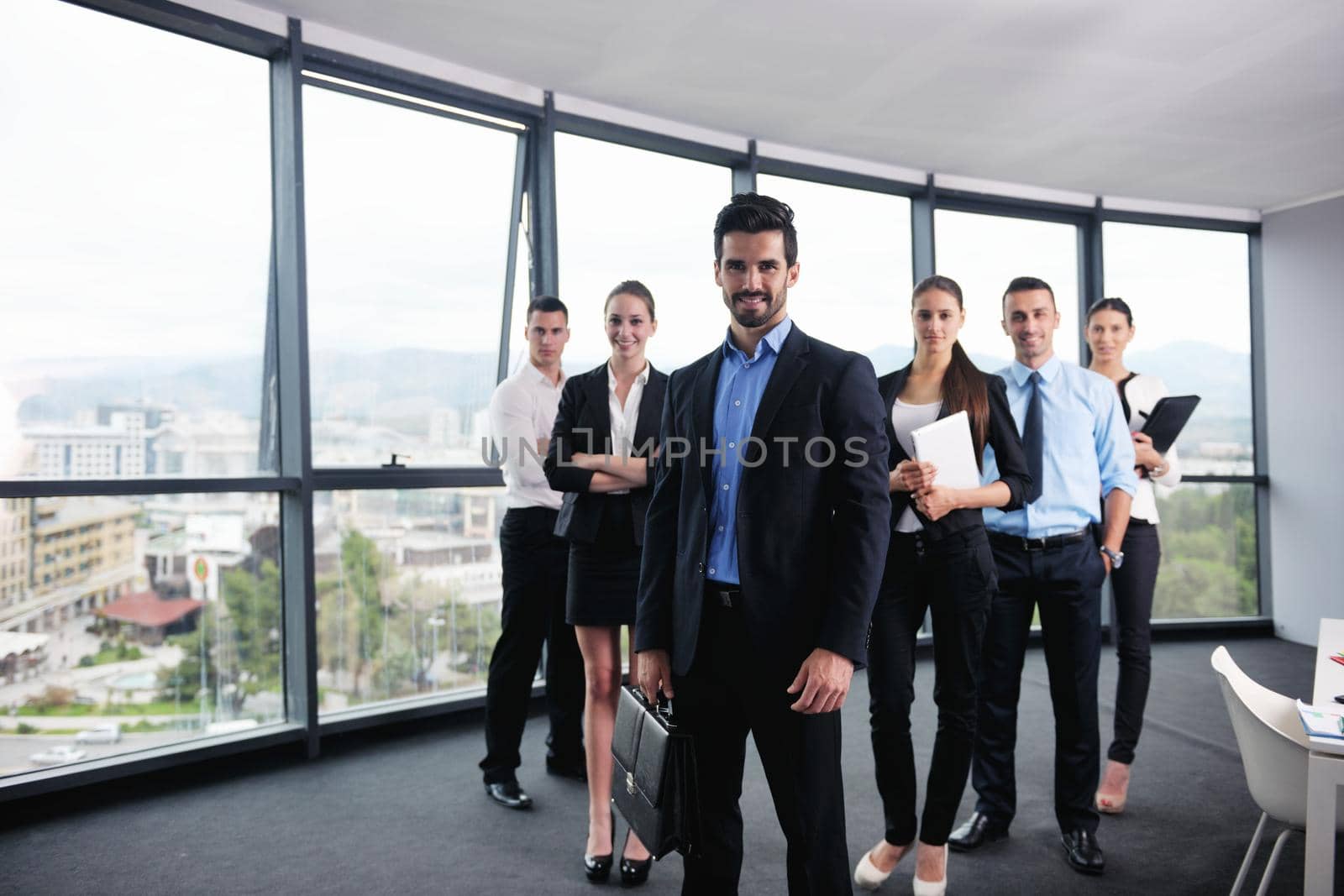 Group of happy young  business people in a meeting at office