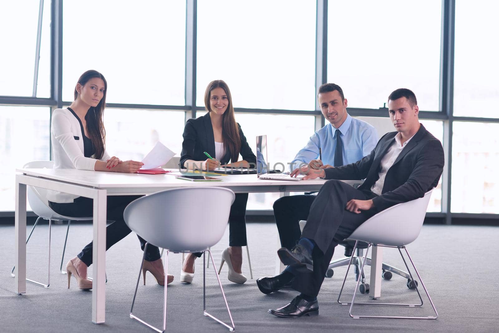 Group of happy young  business people in a meeting at office