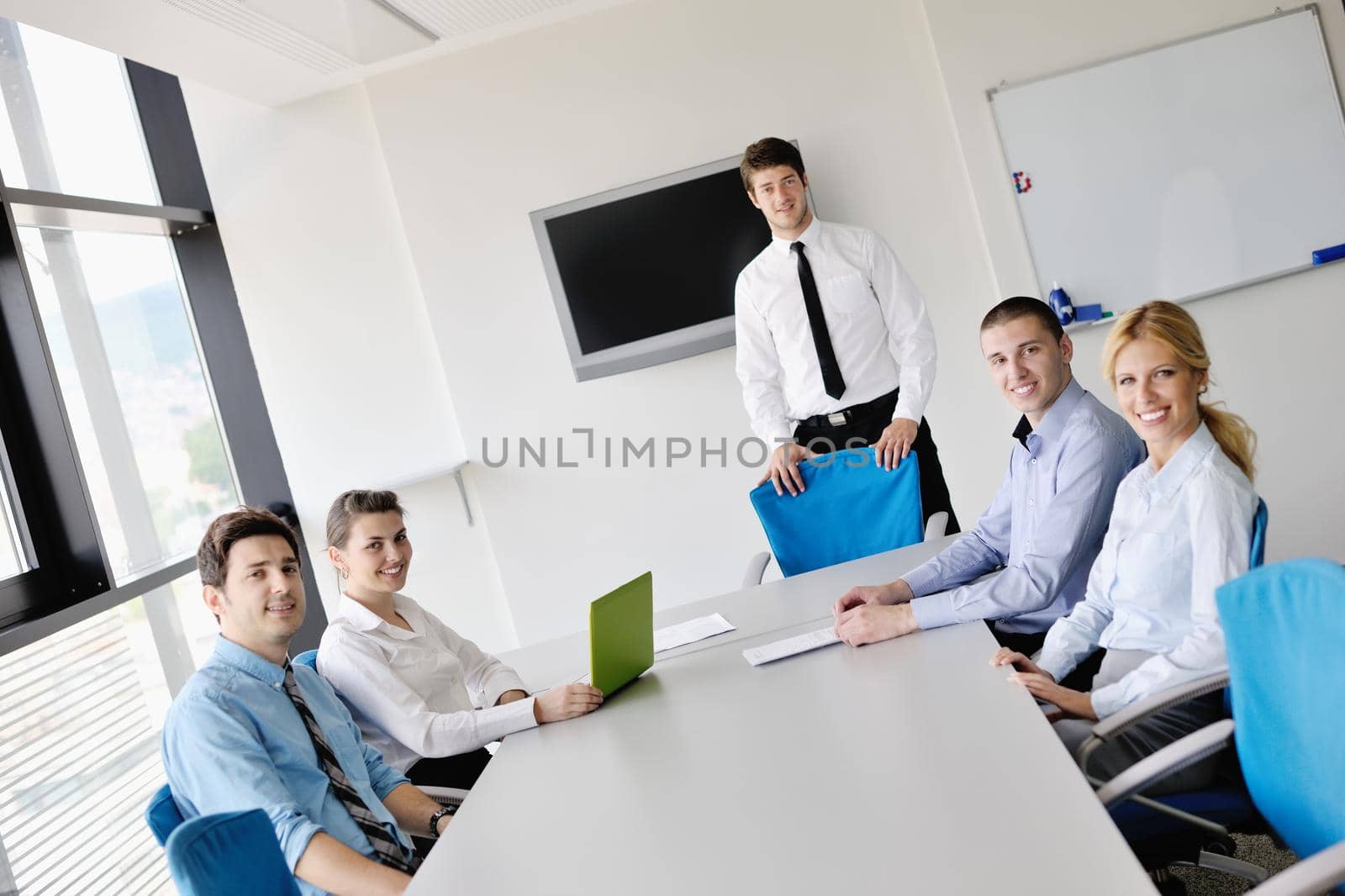 Group of happy young  business people in a meeting at office