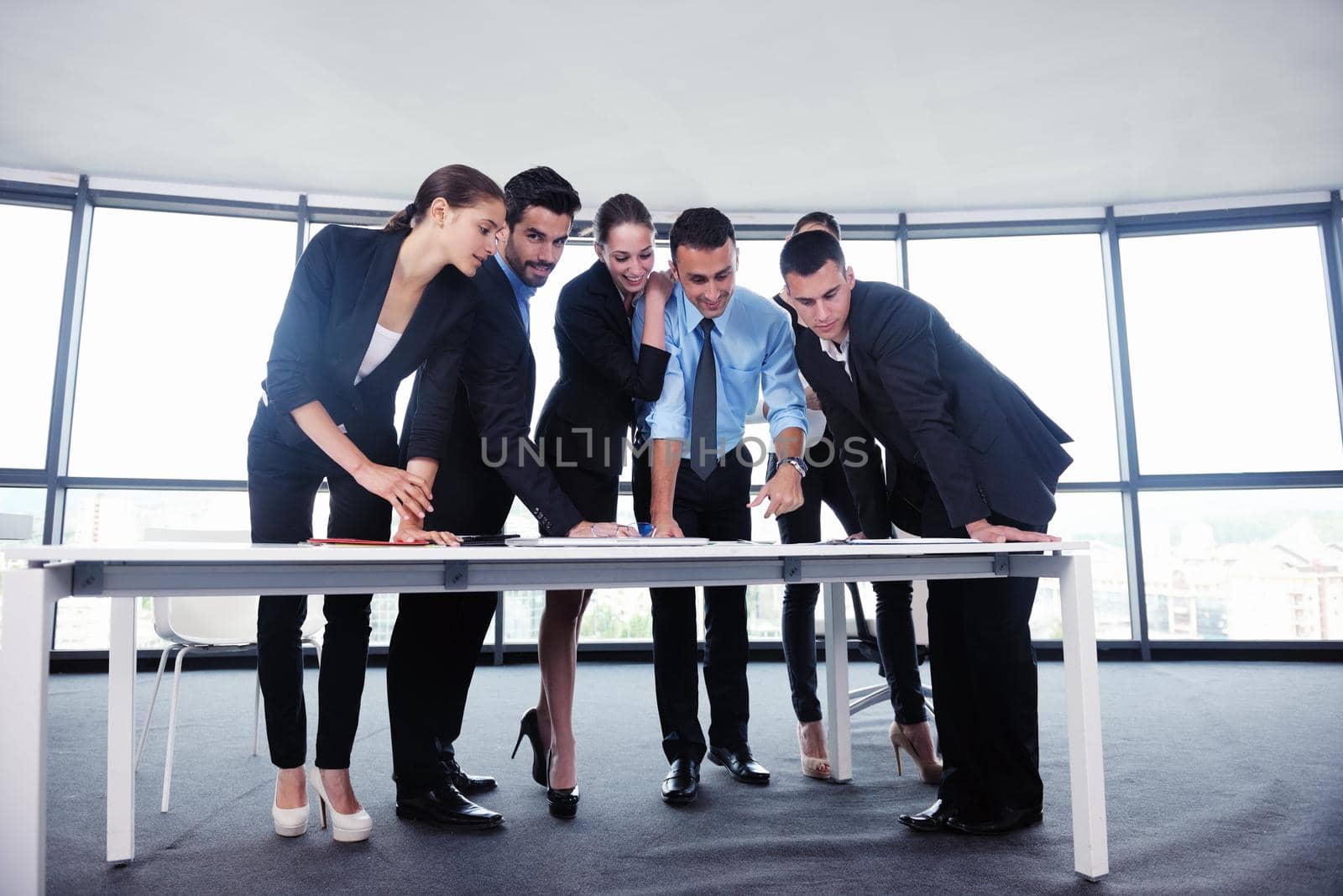 Group of happy young  business people in a meeting at office