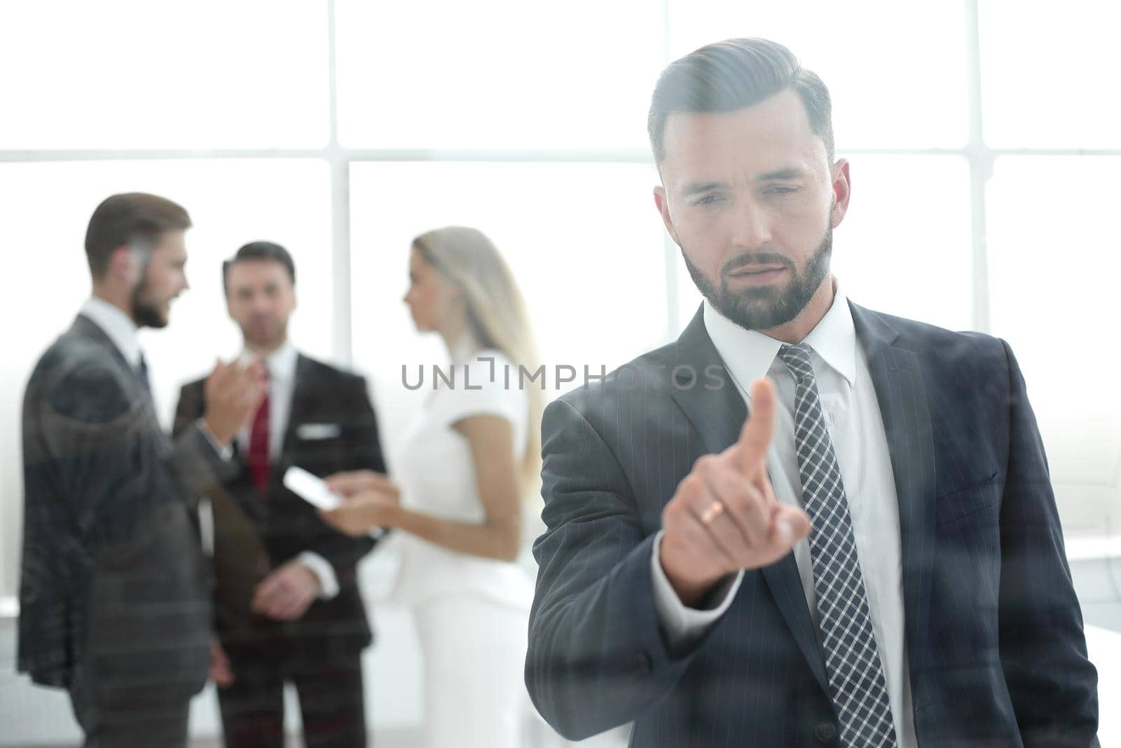 successful businessman pressing his finger on the glass screen by asdf