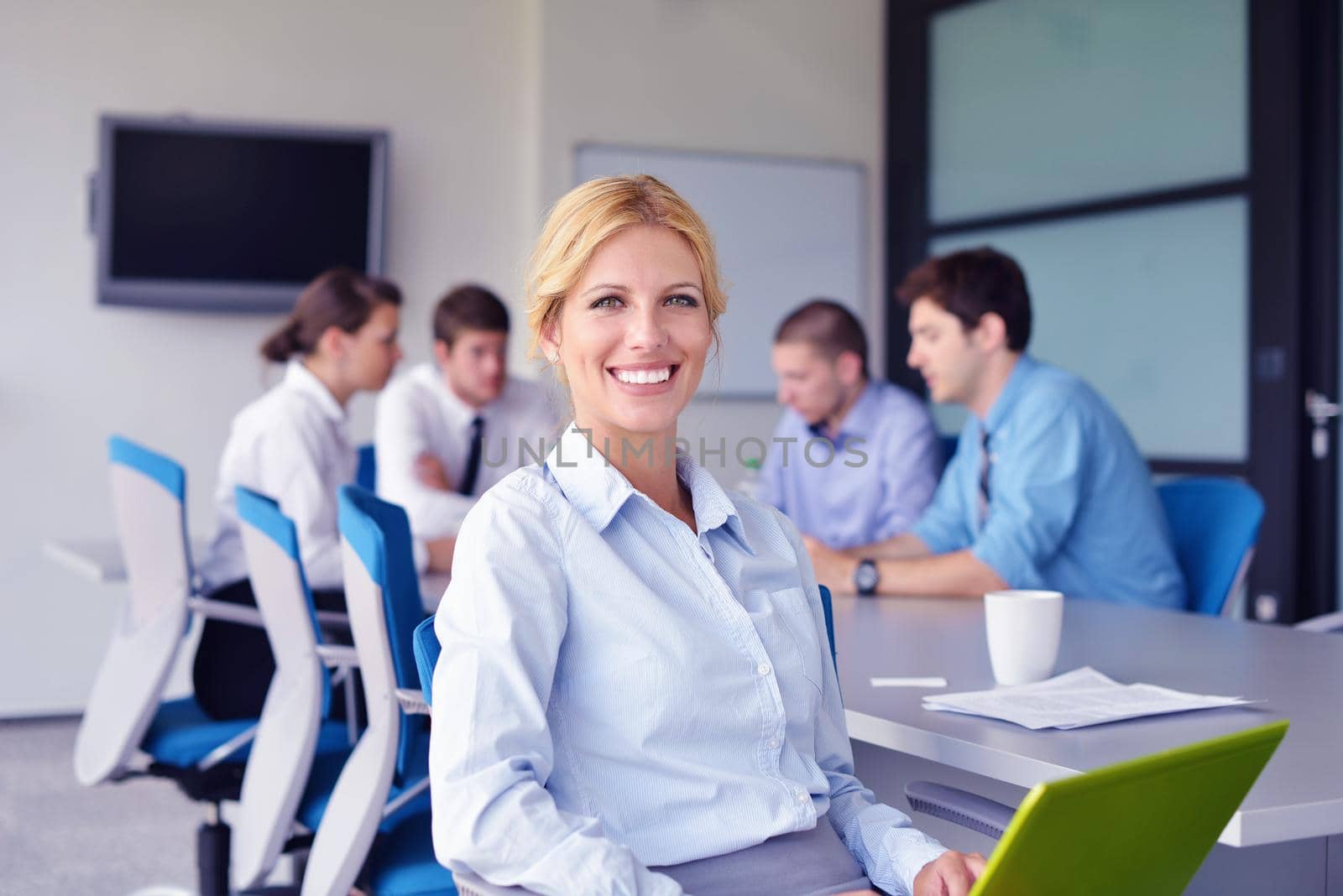 business woman  with her staff,  people group in background at modern bright office indoors