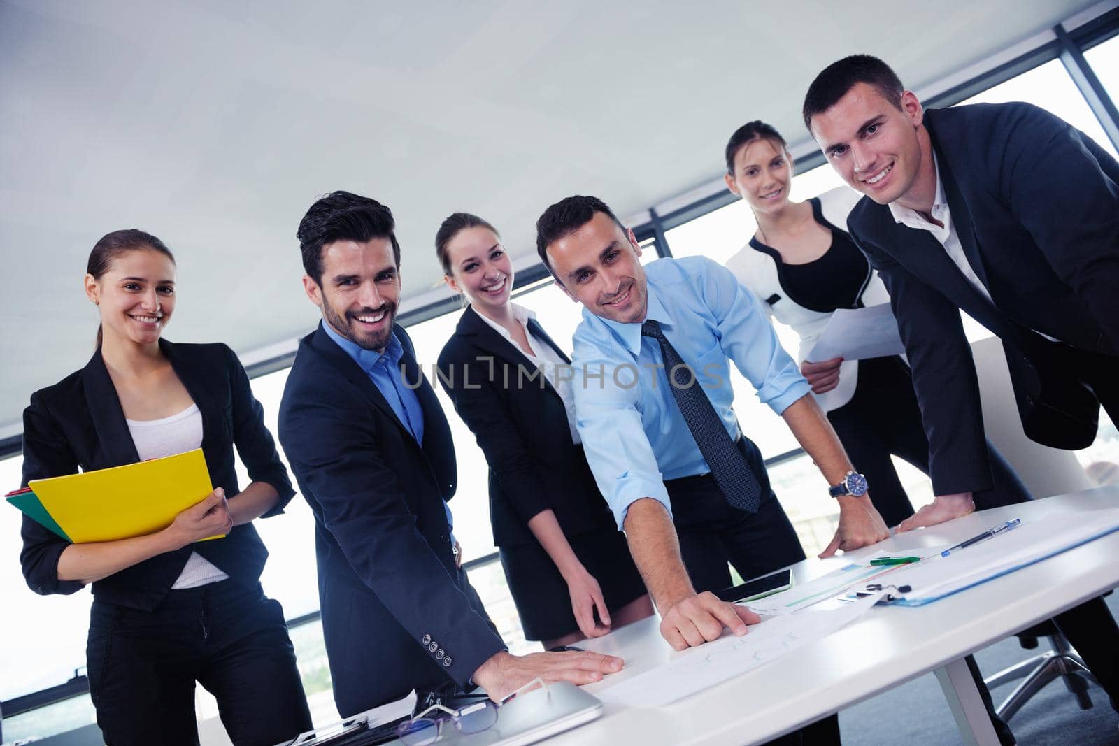 Group of happy young  business people in a meeting at office