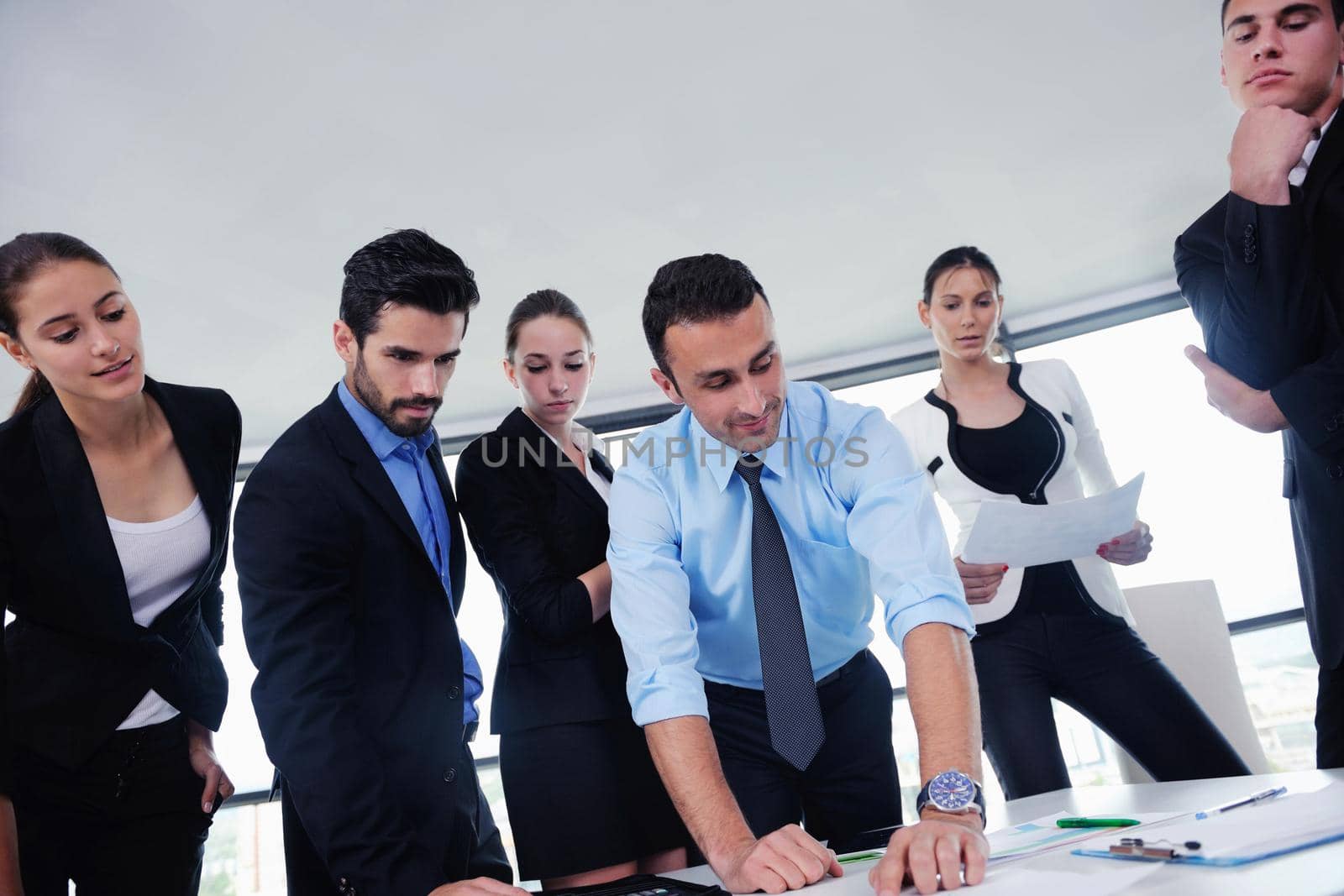 Group of happy young  business people in a meeting at office