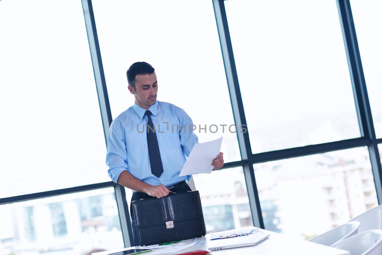 Single adult business man waiting for meeting to begin in Board room