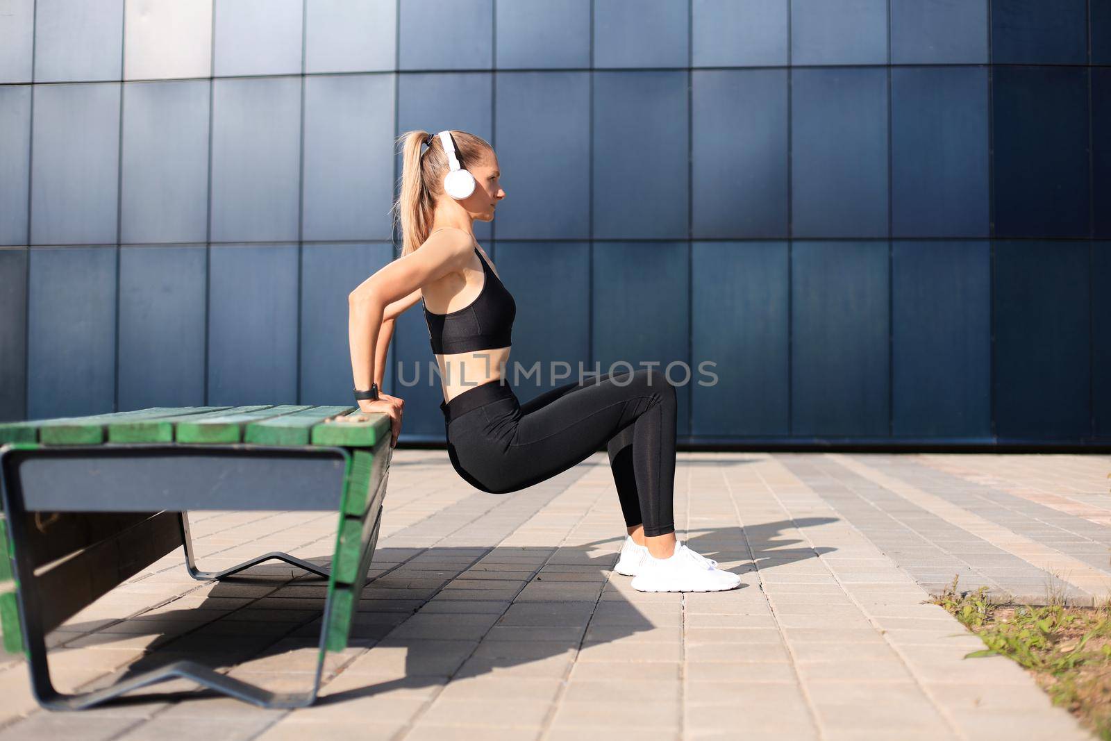 Fitness sporty woman during outdoor exercises workout. by tsyhun