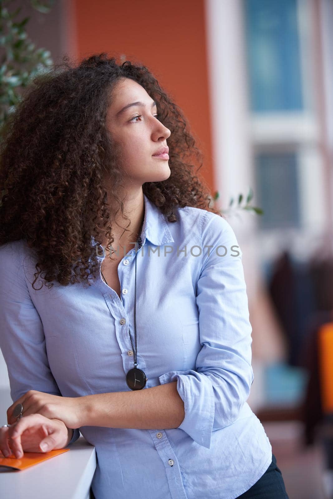 happy young  business woman with curly hairstyle in the modern office