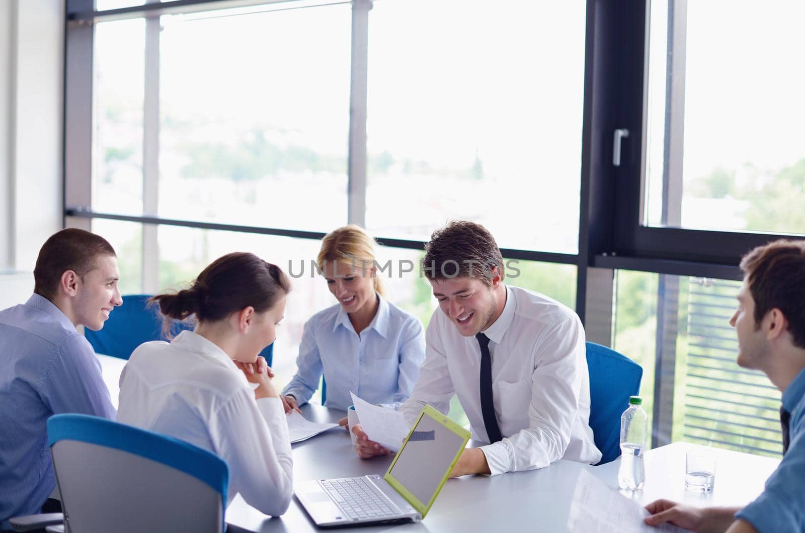 Group of happy young  business people in a meeting at office