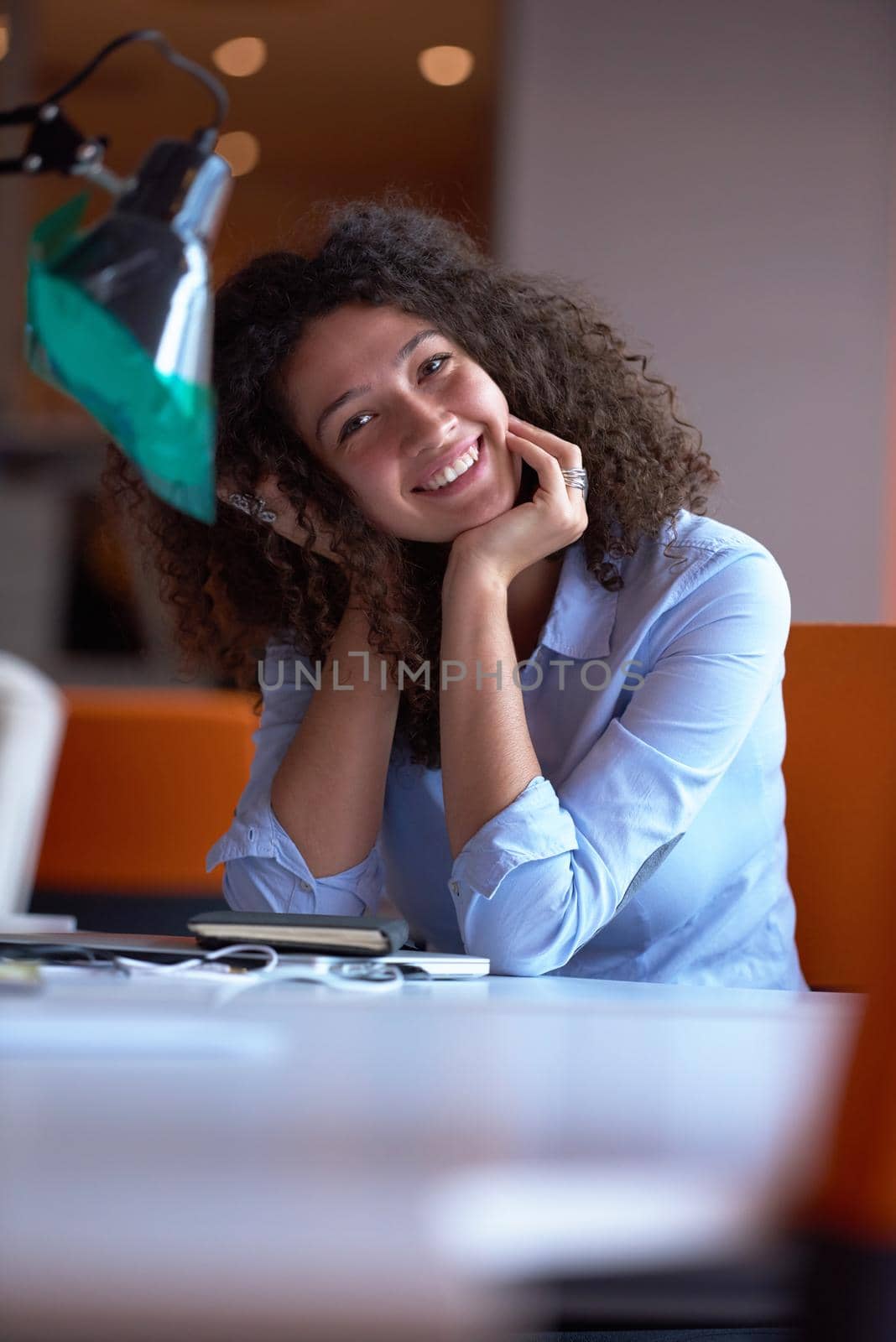 happy young  business woman with curly hairstyle in the modern office