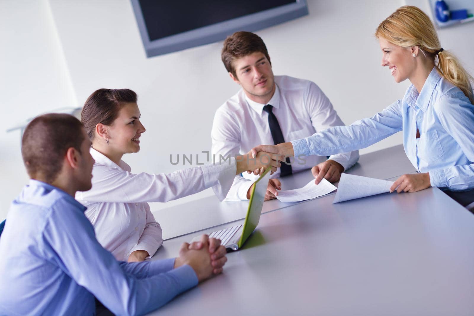 Group of happy young  business people in a meeting at office