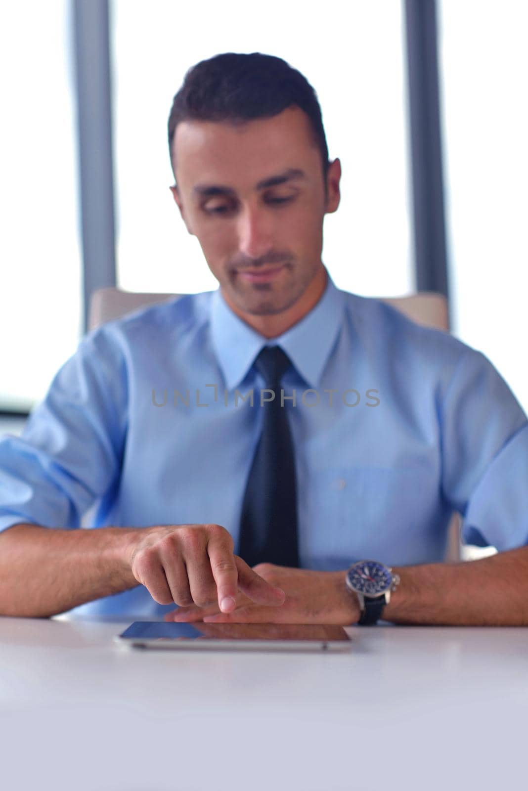 close-up of human hand  business man using tablet compuer at office