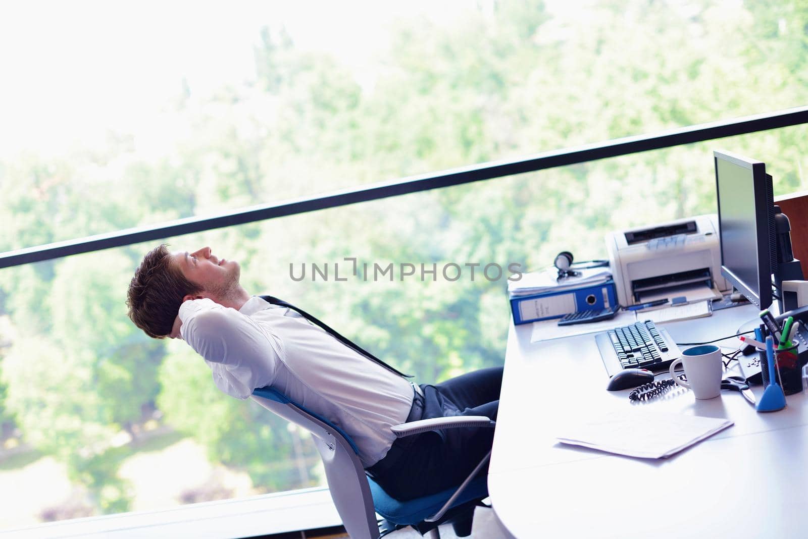 happy young business  man work in modern office on computer