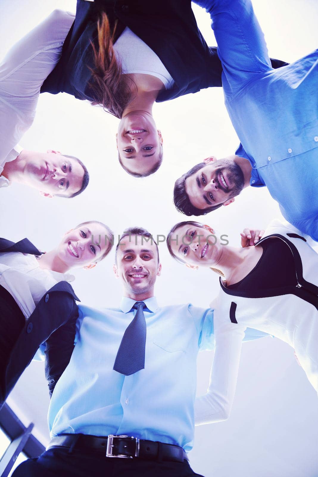 business people group joining hands and representing concept of friendship and teamwork,  low angle view