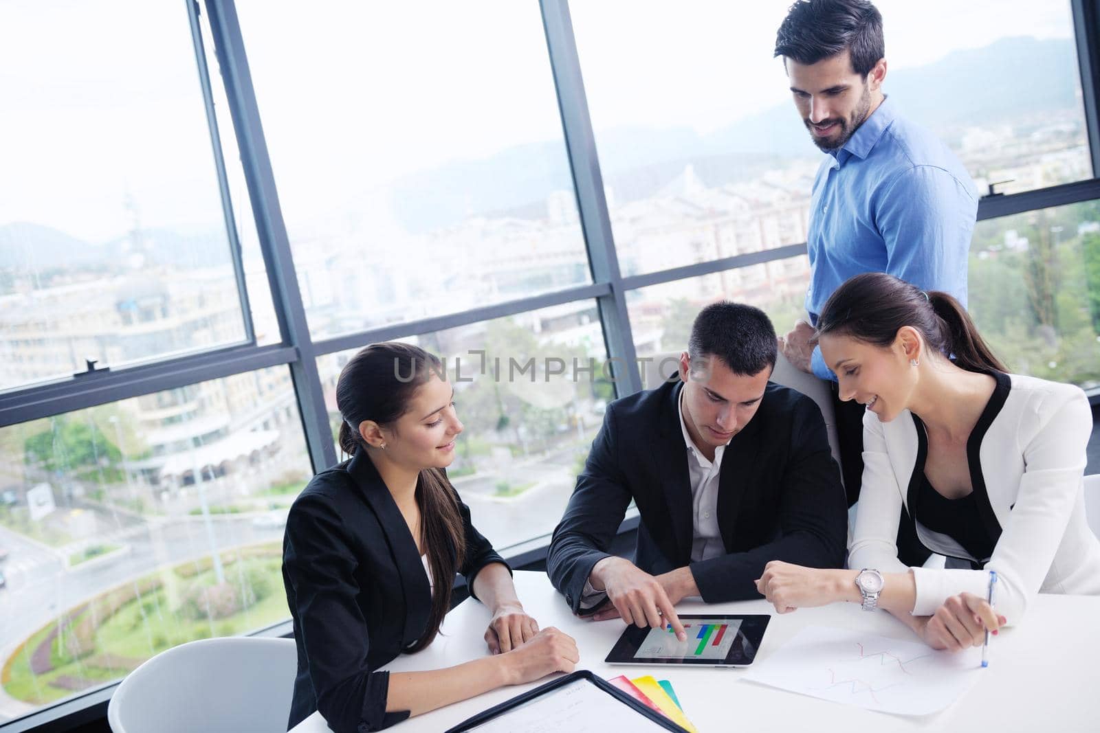 Group of happy young  business people in a meeting at office