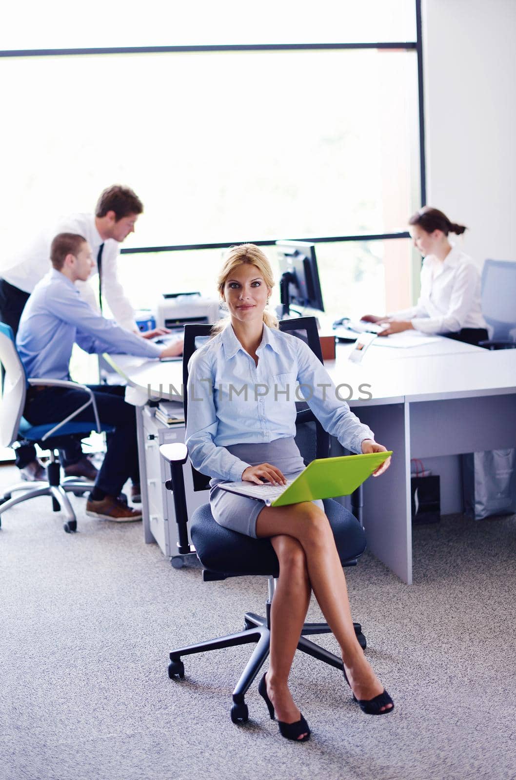 business woman  with her staff,  people group in background at modern bright office indoors