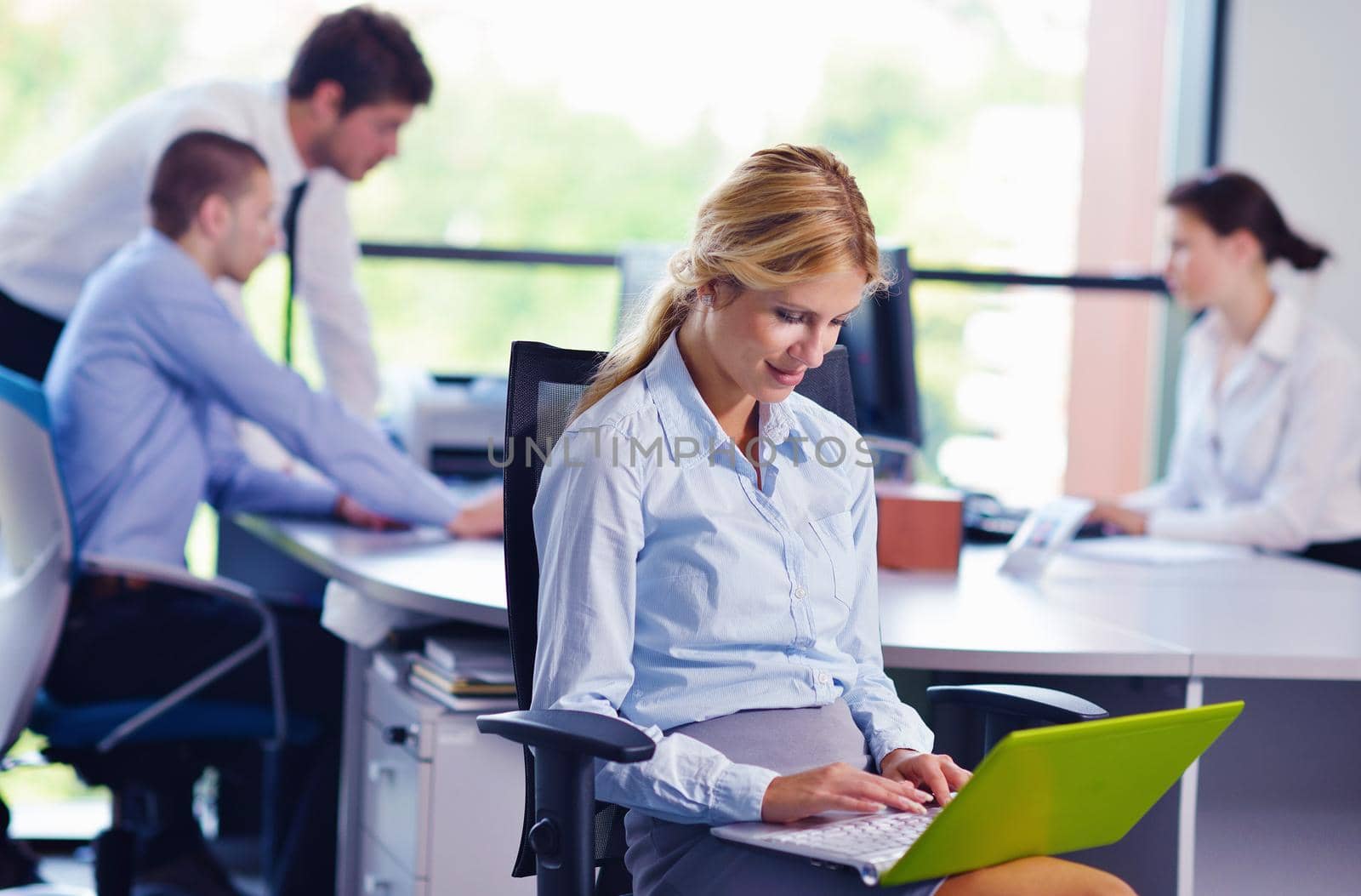 business woman  with her staff,  people group in background at modern bright office indoors