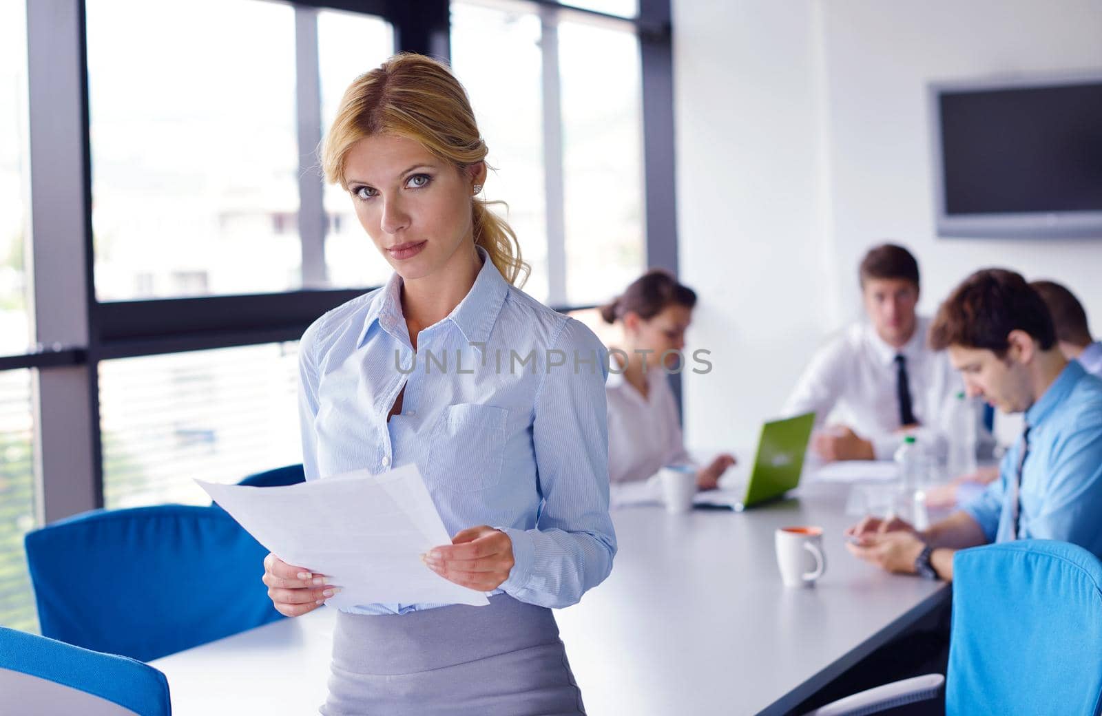 business woman  with her staff,  people group in background at modern bright office indoors