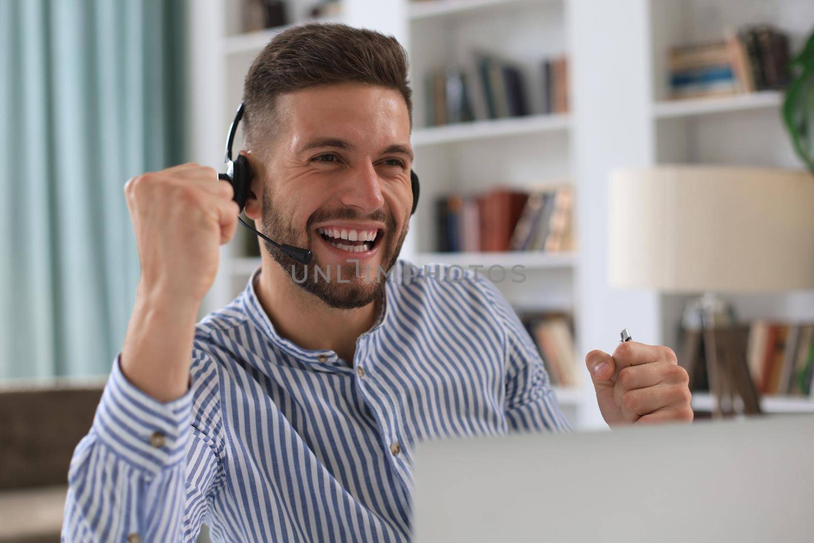 Smiling young business man having video call in office