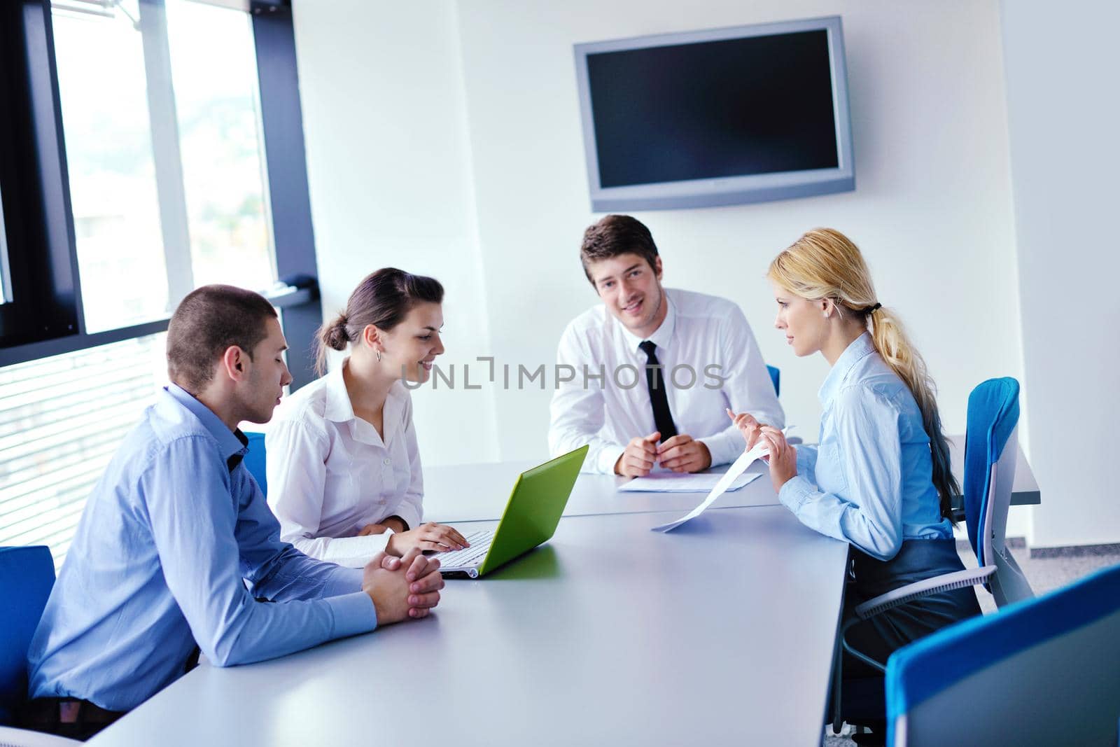 Group of happy young  business people in a meeting at office