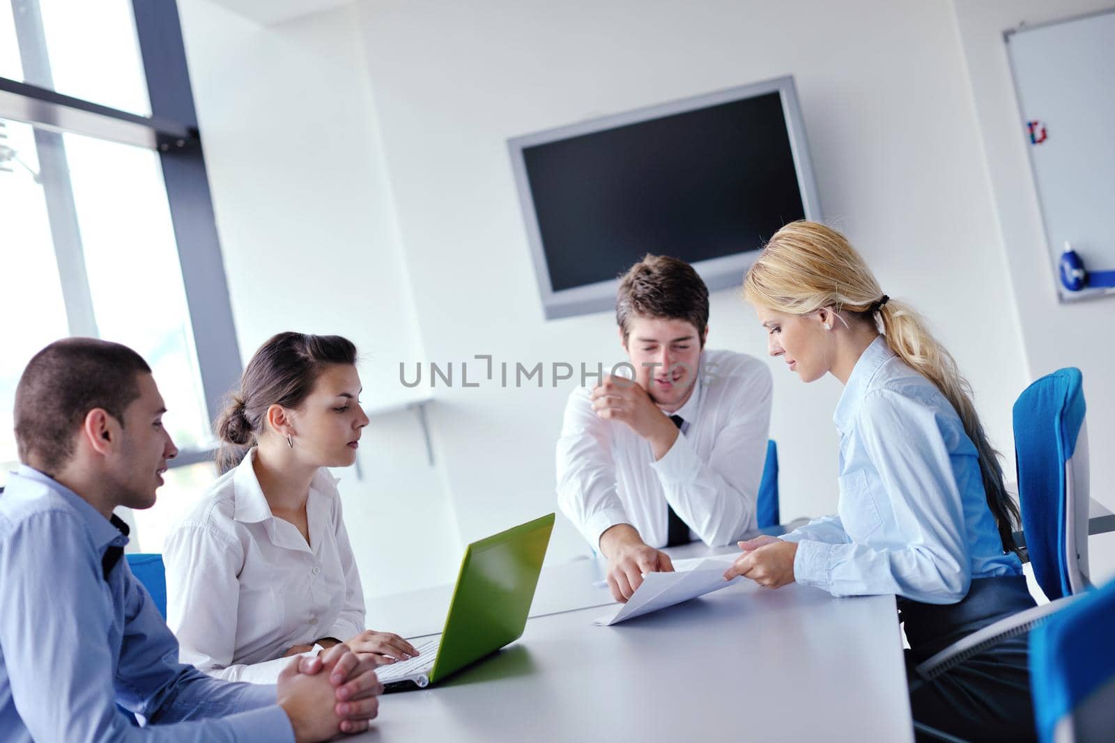 Group of happy young  business people in a meeting at office