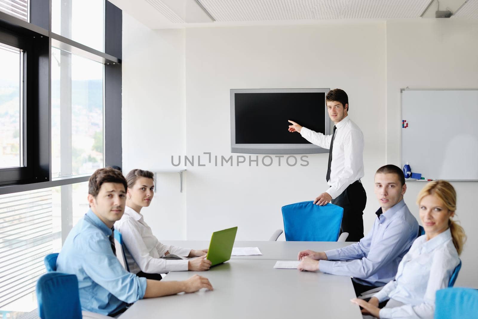 Group of happy young  business people in a meeting at office