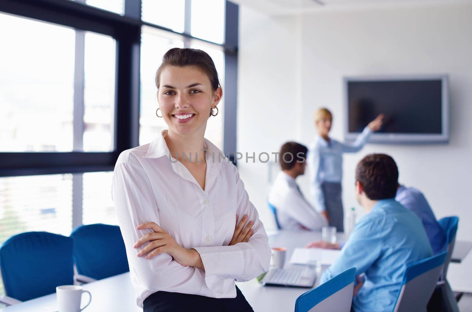 business woman  with her staff,  people group in background at modern bright office indoors