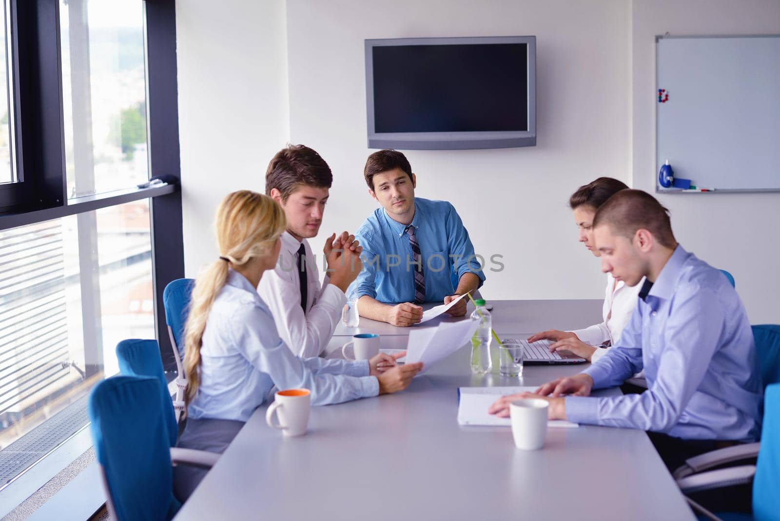 Group of happy young  business people in a meeting at office