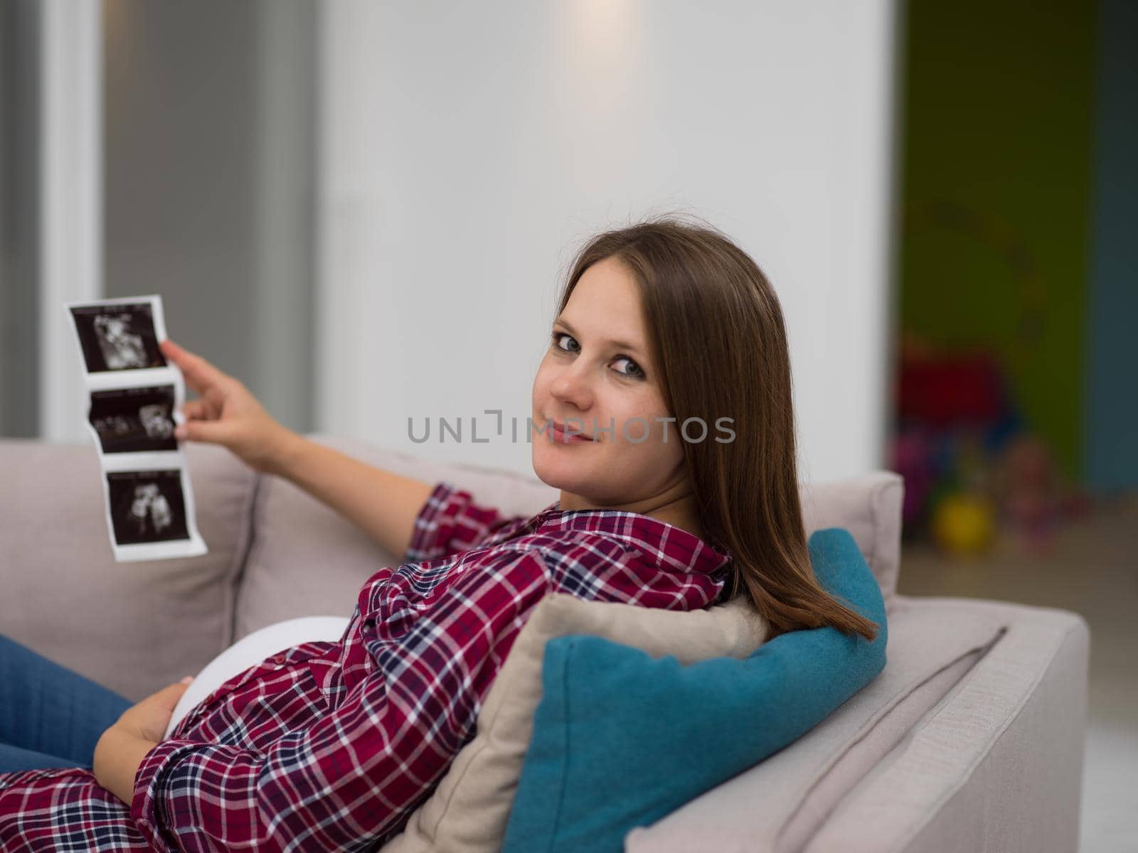 pregnant woman looking baby's ultrasound by dotshock