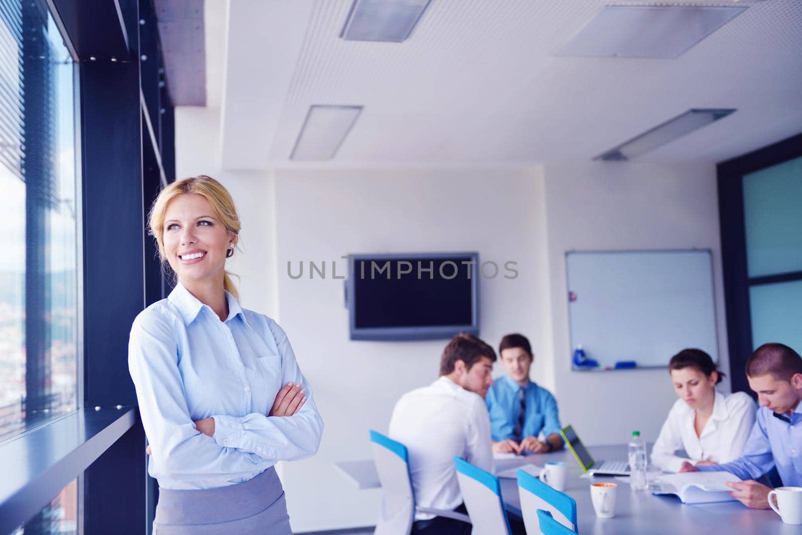 business woman  with her staff,  people group in background at modern bright office indoors