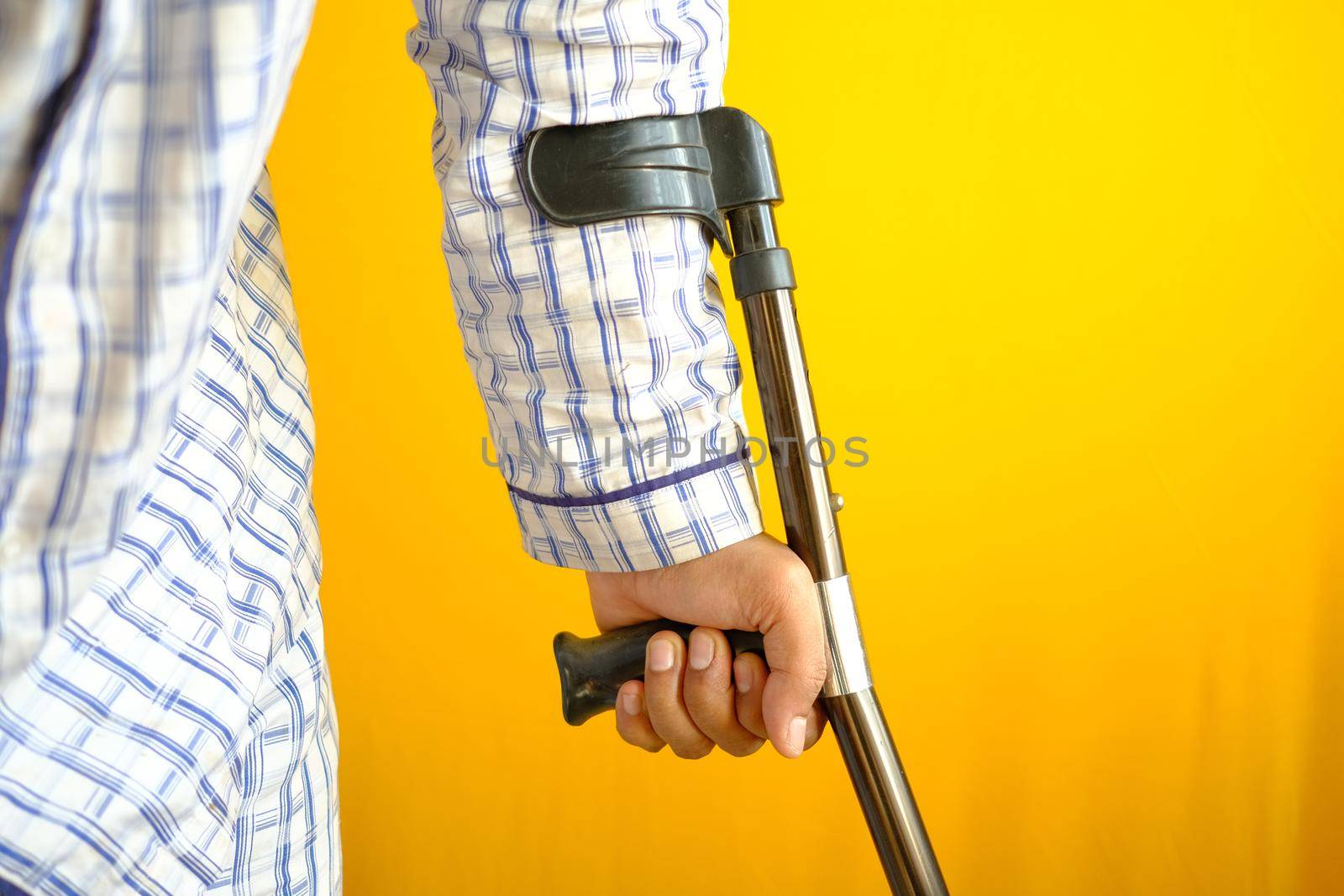 young man with broken leg on crutches