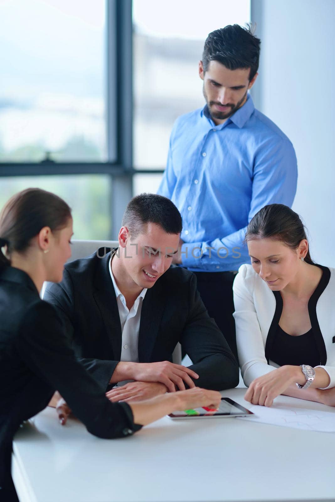 Group of happy young  business people in a meeting at office