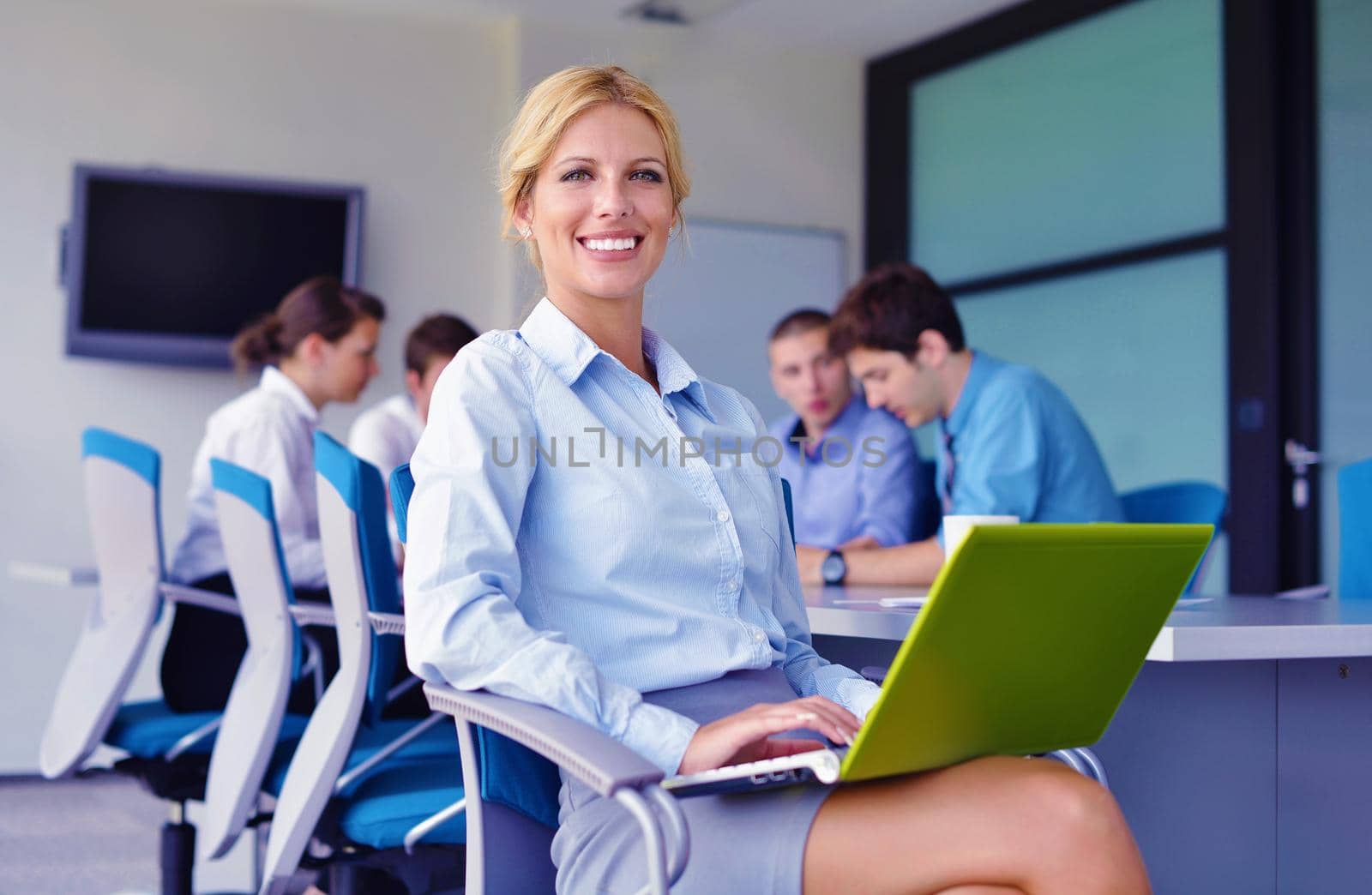 business woman  with her staff,  people group in background at modern bright office indoors