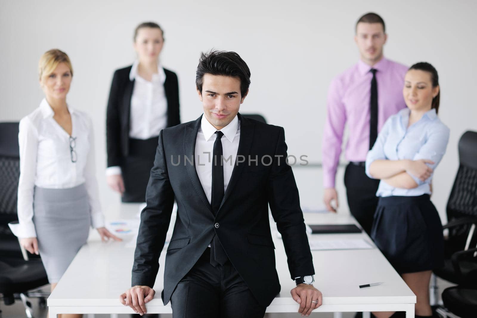 Confident young business man attending a meeting with his colleagues