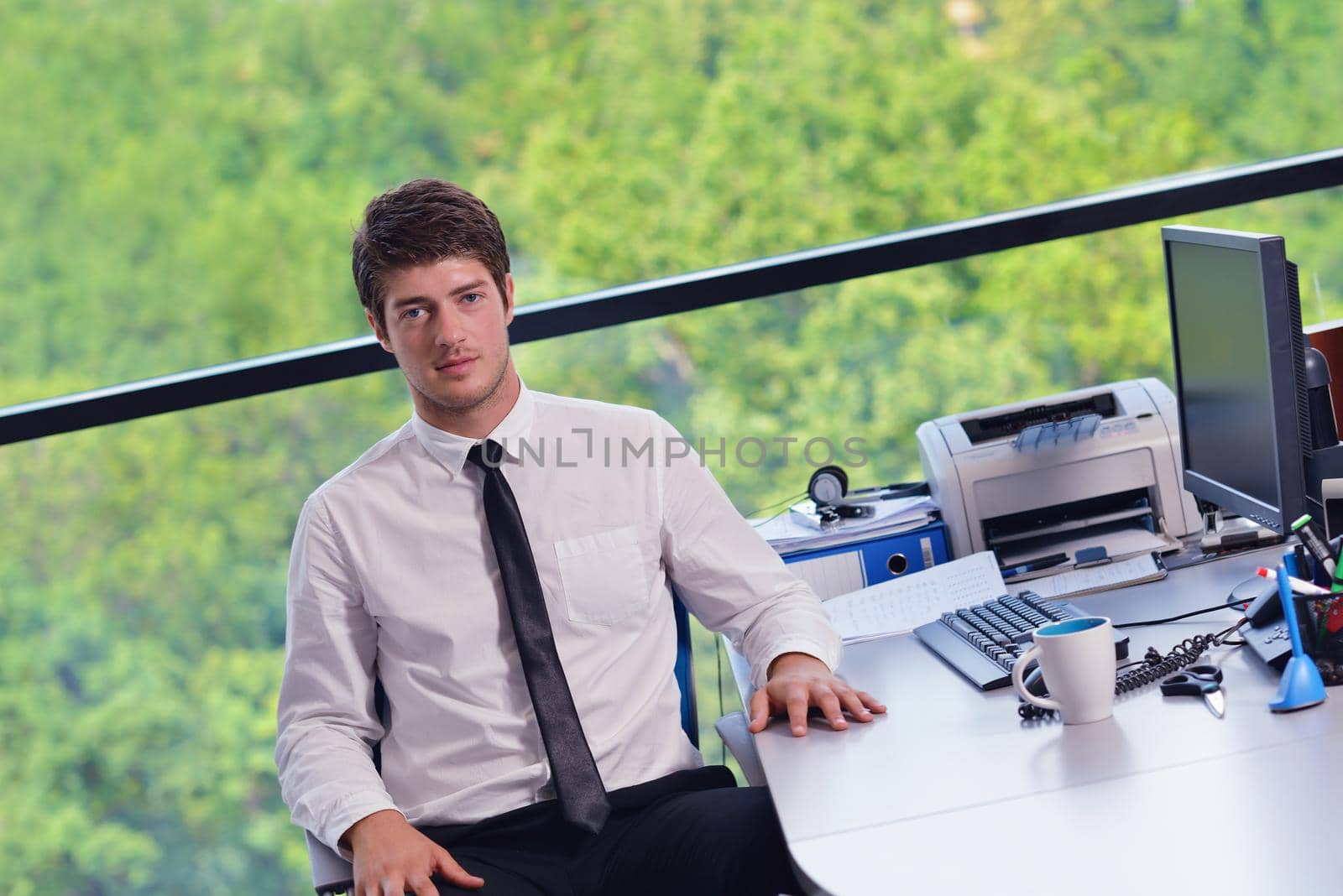 happy young business  man work in modern office on computer