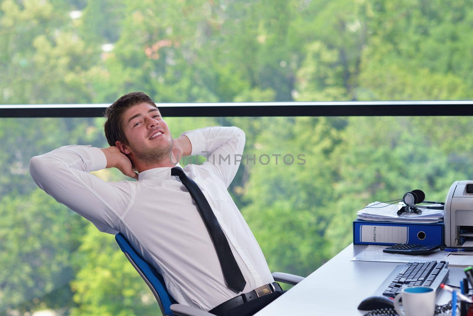 happy young business man at office by dotshock