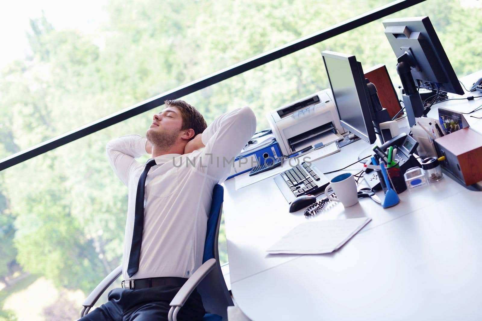 happy young business  man work in modern office on computer