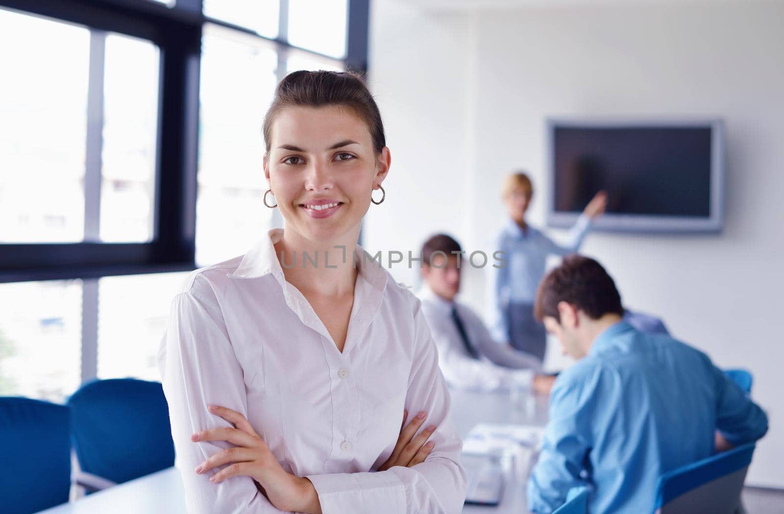 business woman  with her staff,  people group in background at modern bright office indoors