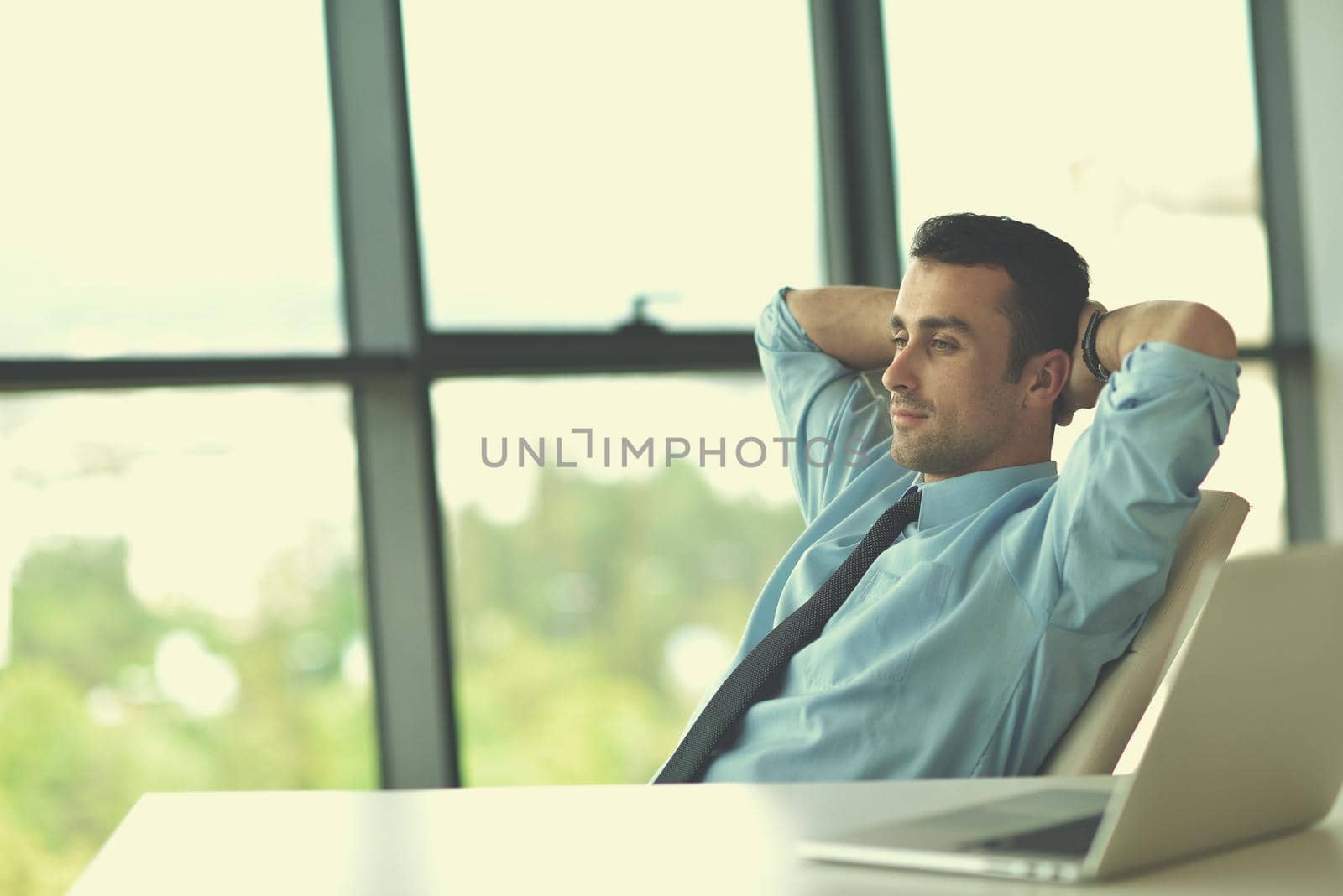 happy young business  man work in modern office on computer