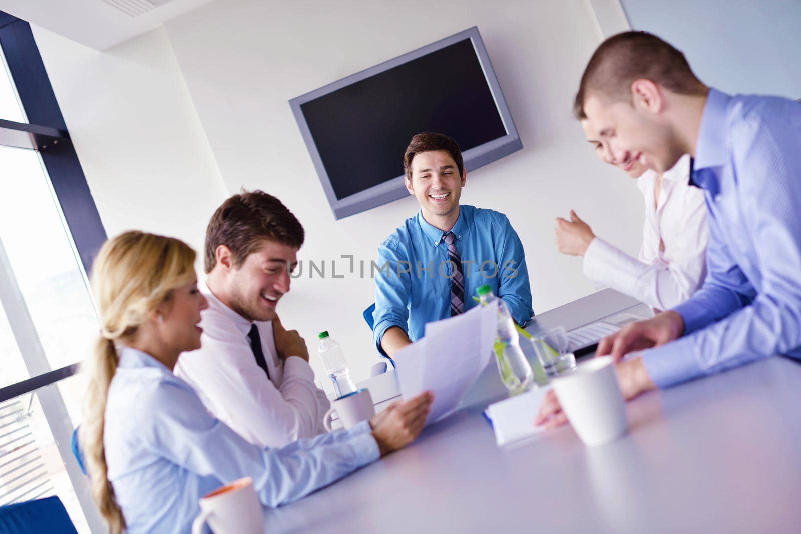 Group of happy young  business people in a meeting at office