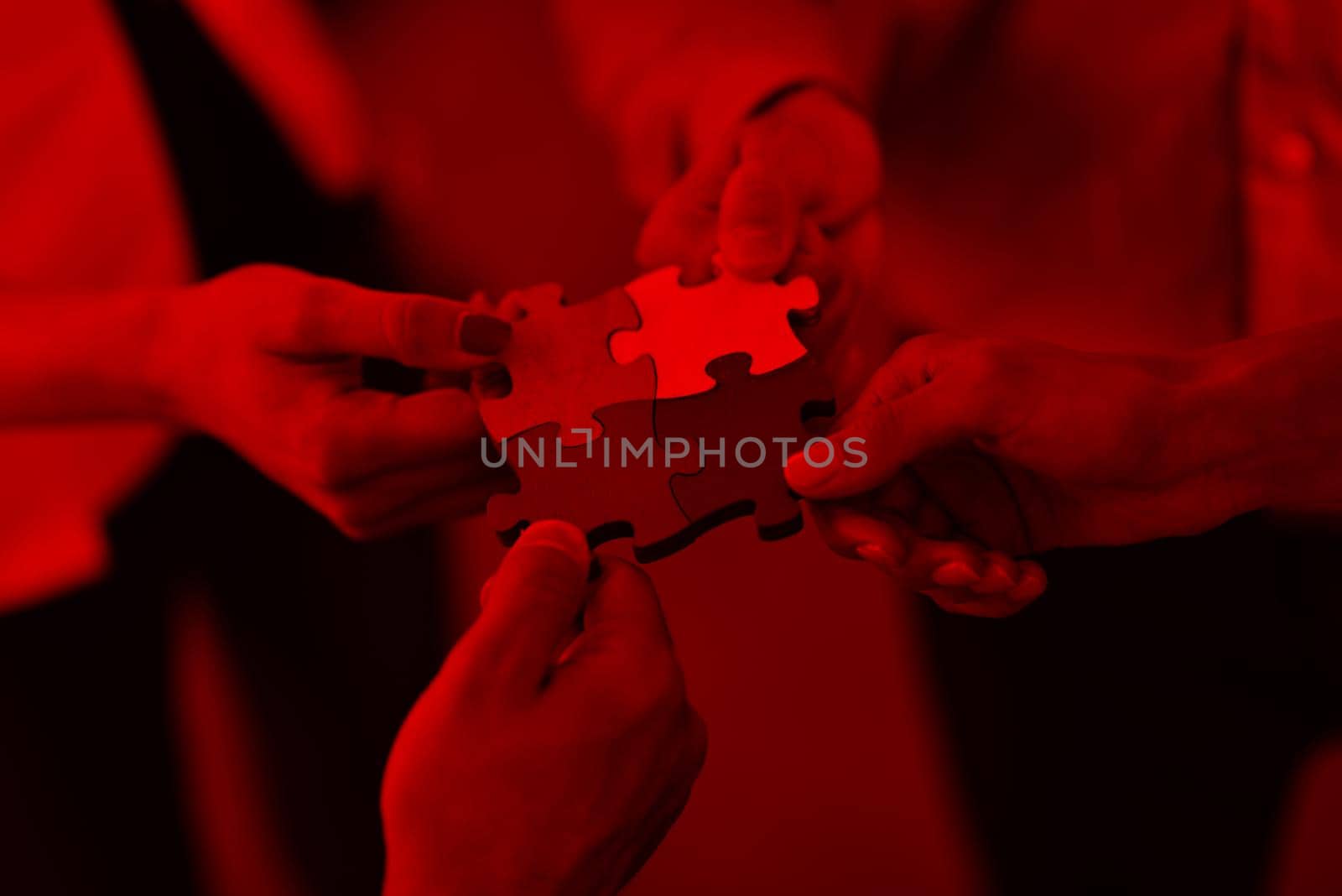 Group of business people assembling jigsaw puzzle by dotshock