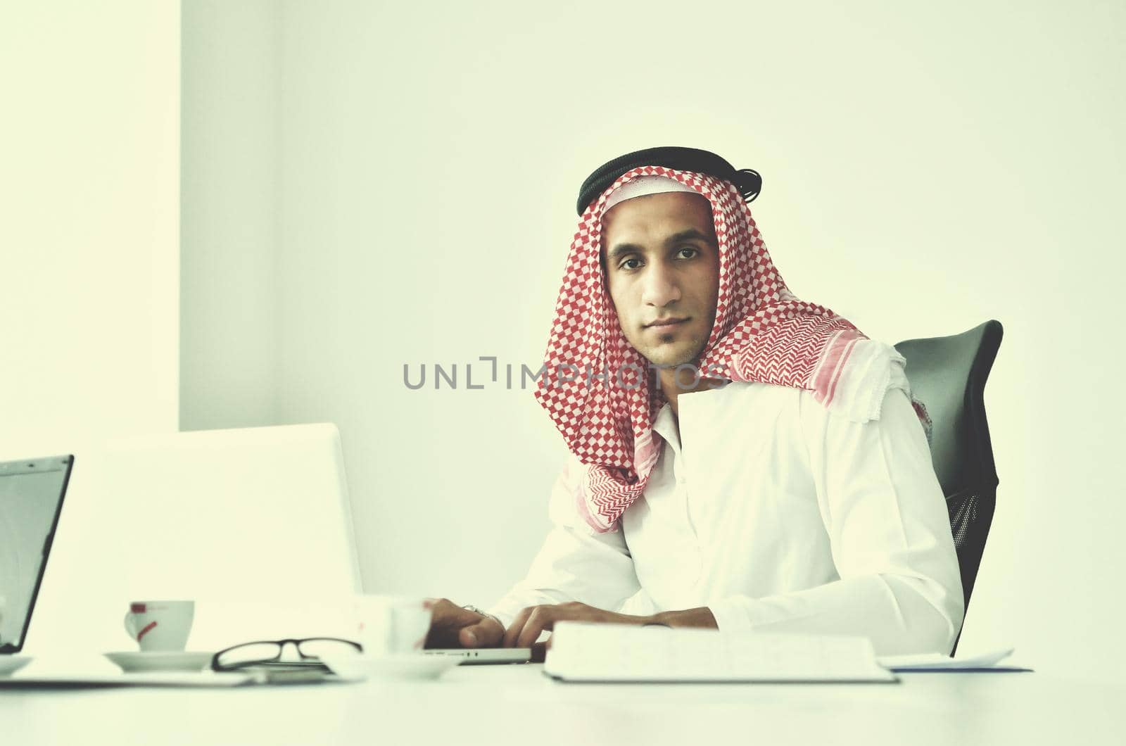 happy young arabic business man working at bright office