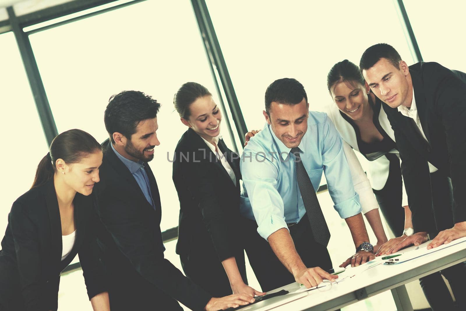 Group of happy young  business people in a meeting at office