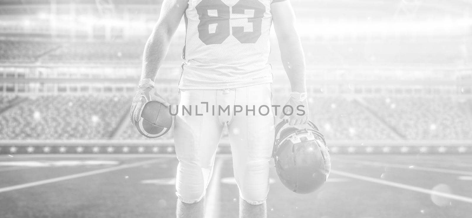 Closeup Portrait of a strong muscular American Football Player on big modern stadium field with lights and flares